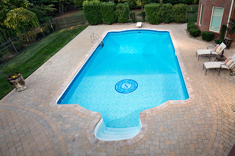 Pool paving around a backyard swimming pool